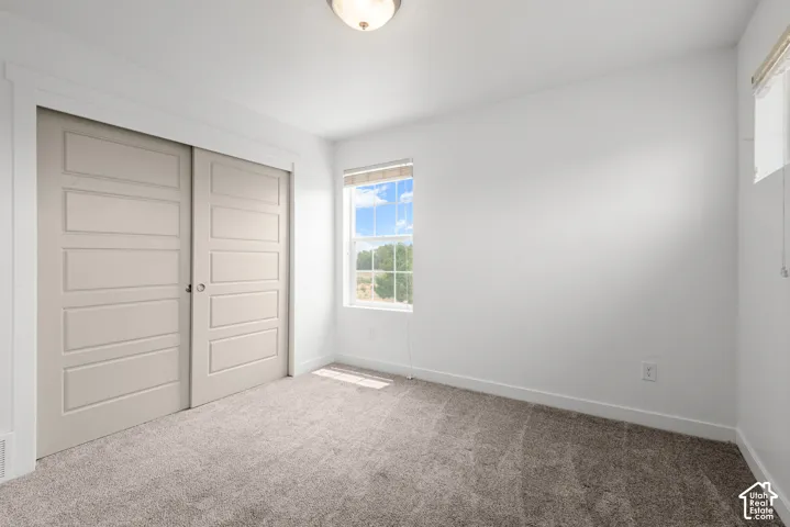 Room featuring neutral-toned carpeting and white walls