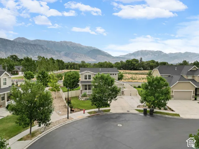 Residential street featuring a cul-de-sac and mountain backdrop