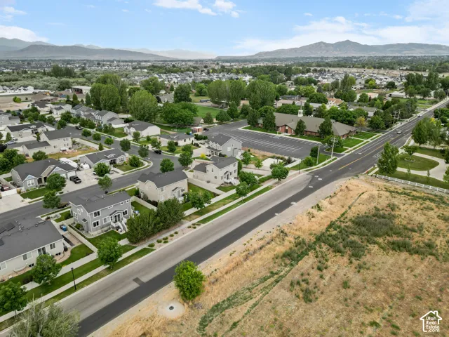 Aerial perspective showcasing a residential neighborhood with mountain backdrops