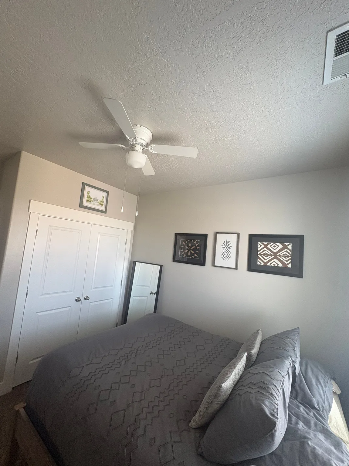 Bedroom featuring a ceiling fan, window-mounted air conditioning unit, and carpeted flooring