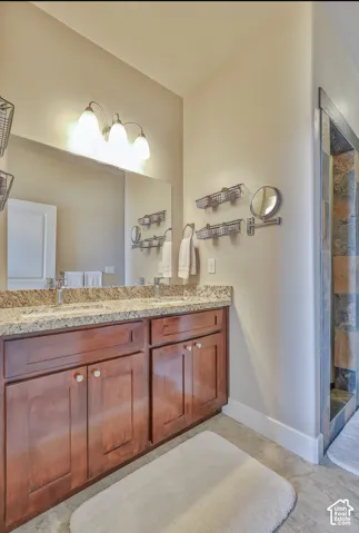 Master Bathroom. Dual vanity with wood cabinetry, granite countertop, and integrated sinks