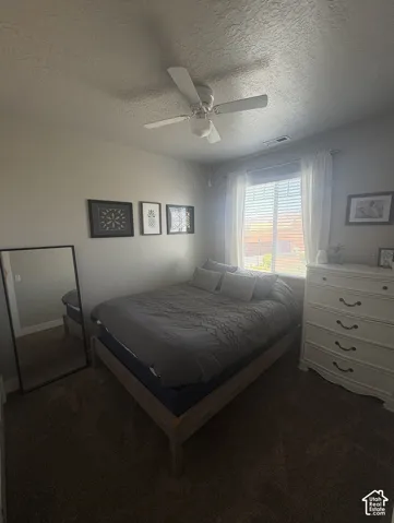 Carpeted room with window and a ceiling fan