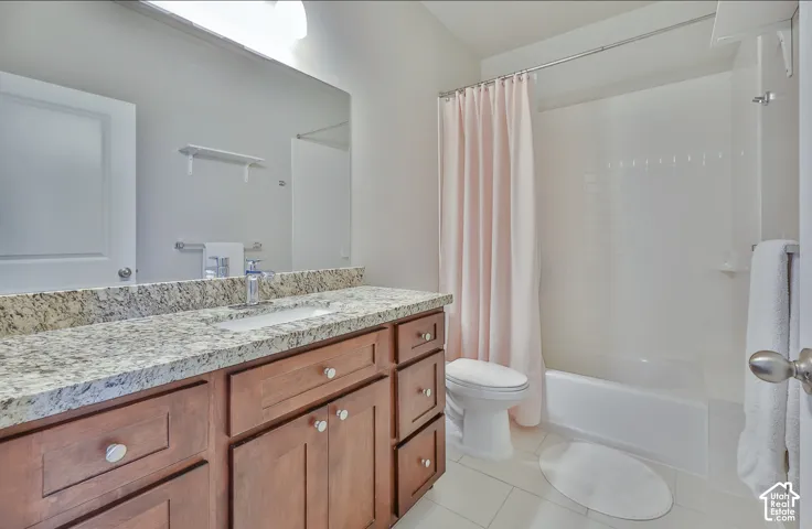 Bathroom with a single vanity featuring a granite-look countertop and wood-finish cabinetry