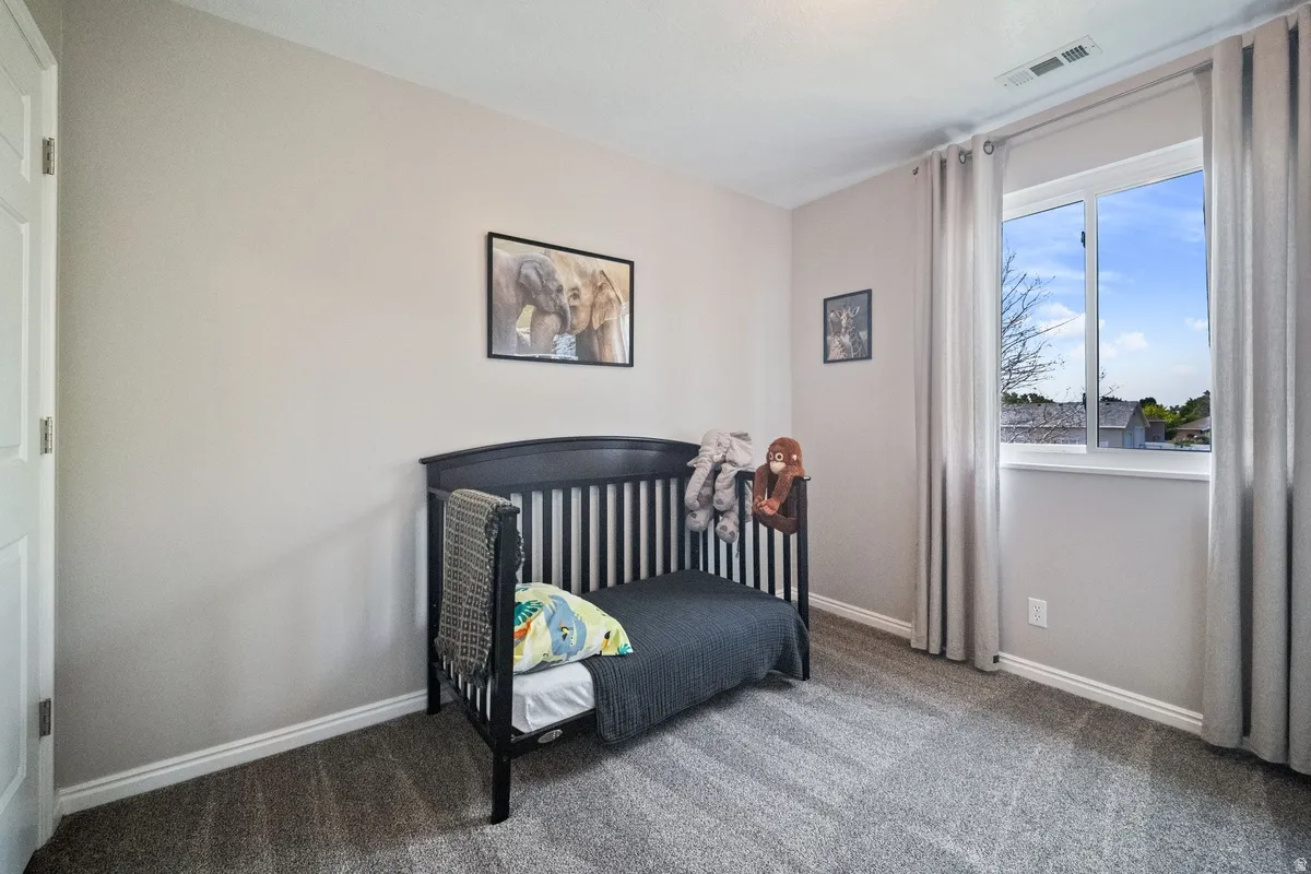 Room featuring neutral wall tones and plush gray carpeting