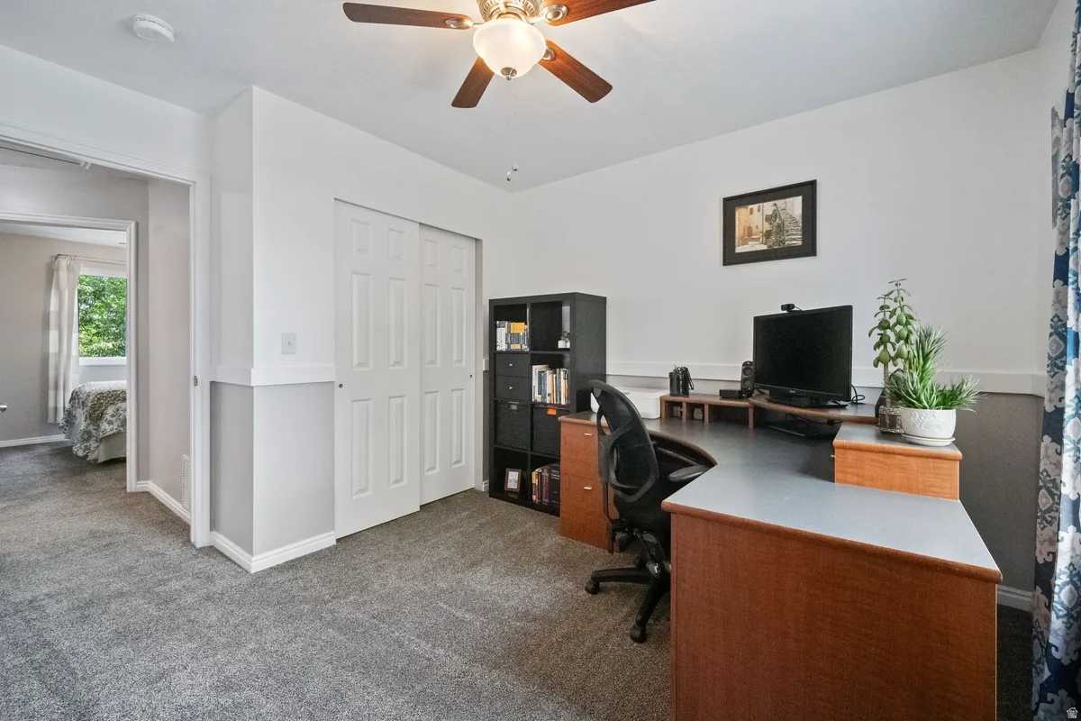 Interior room featuring light gray carpeting and white walls with a gray wainscoting detail