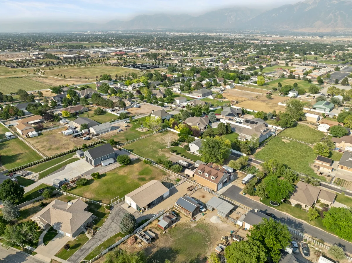 Expansive aerial landscape highlighting a residential neighborhood with distant mountain ranges