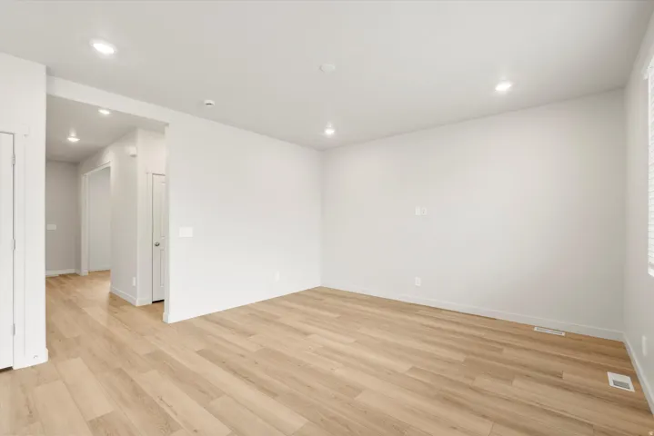 Spacious interior featuring light wood-finish flooring, recessed lighting, and a neutral color palette