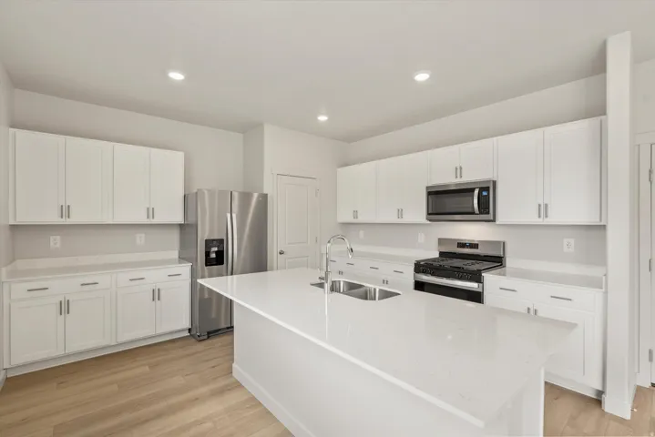 Modern kitchen featuring an expansive center island with an undermount double sink