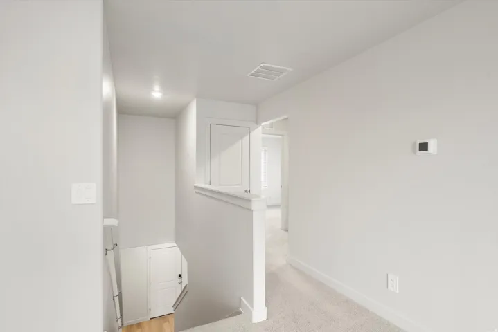 Upper-level hallway with neutral carpeting and light wall finishes
