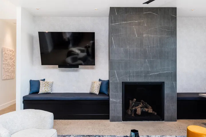 Contemporary fireplace with textured tile surround and recessed hearth