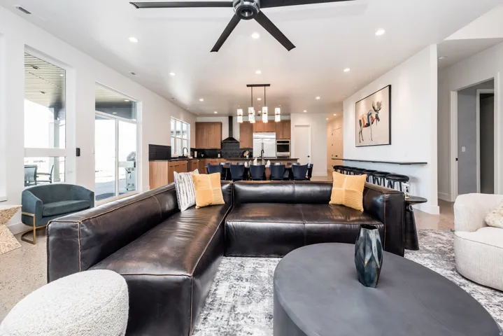 Open-concept living space featuring a modern ceiling fan, recessed lighting, and large sliding glass doors