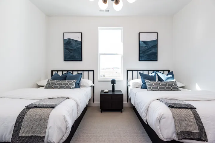 Bright room with a central window, two framed art pieces, and a contemporary ceiling light fixture