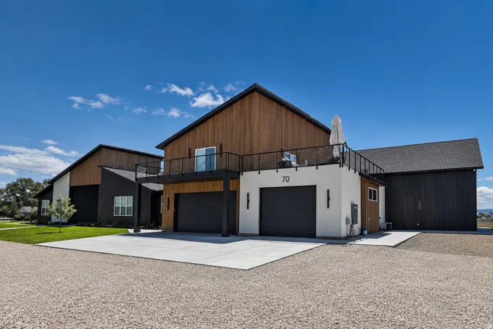Modern barn-style architecture featuring wood-finish siding and dark vertical paneling