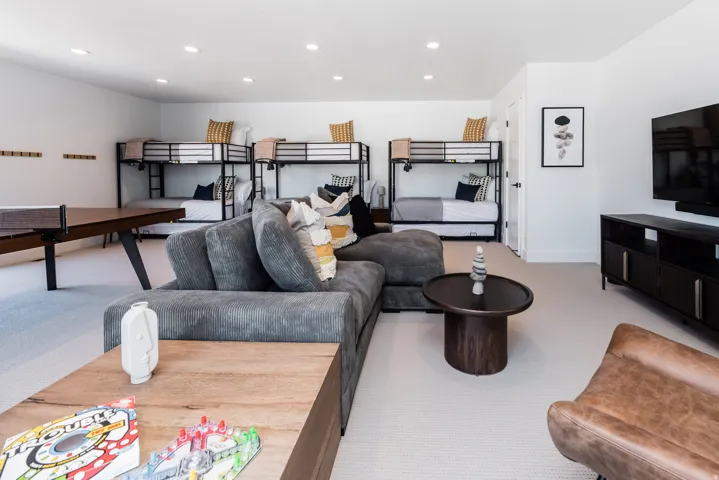 Spacious entertainment room featuring recessed lighting and light-colored carpeting