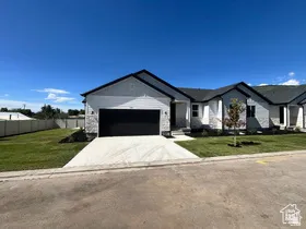 Contemporary exterior with white siding and gray stone accents