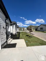 Modern residential exterior featuring horizontal siding and stone veneer accents