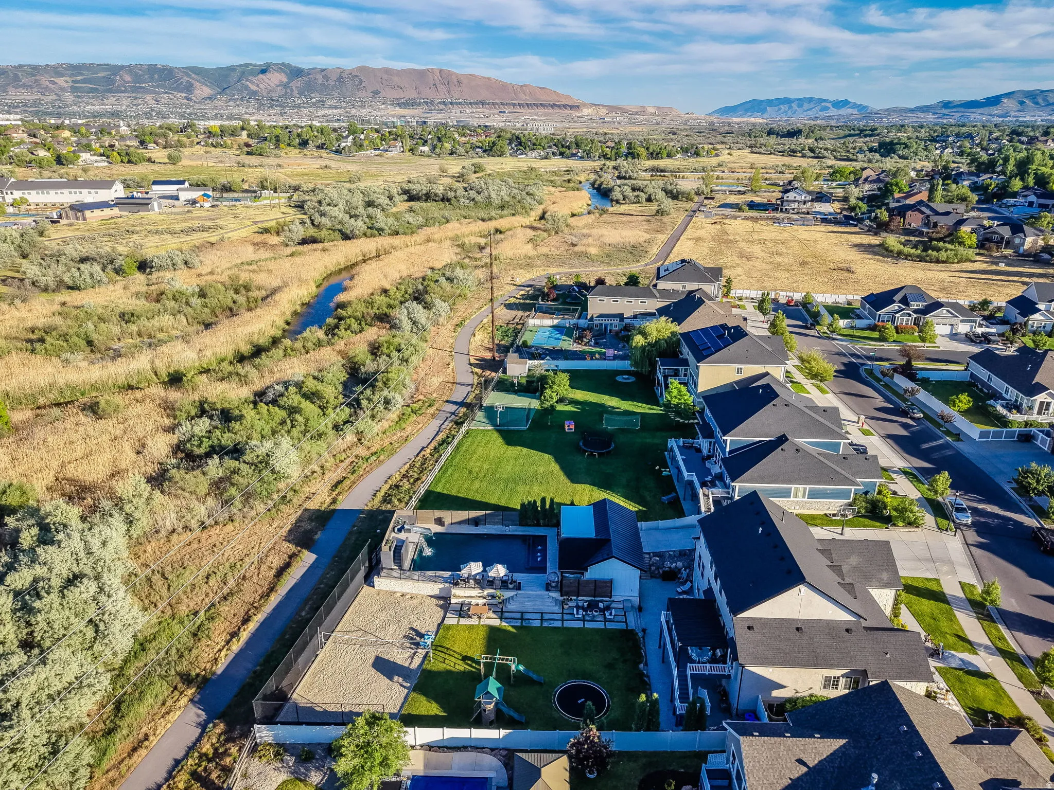 Expansive property featuring a private swimming pool, dedicated sports court, and a large fenced yard