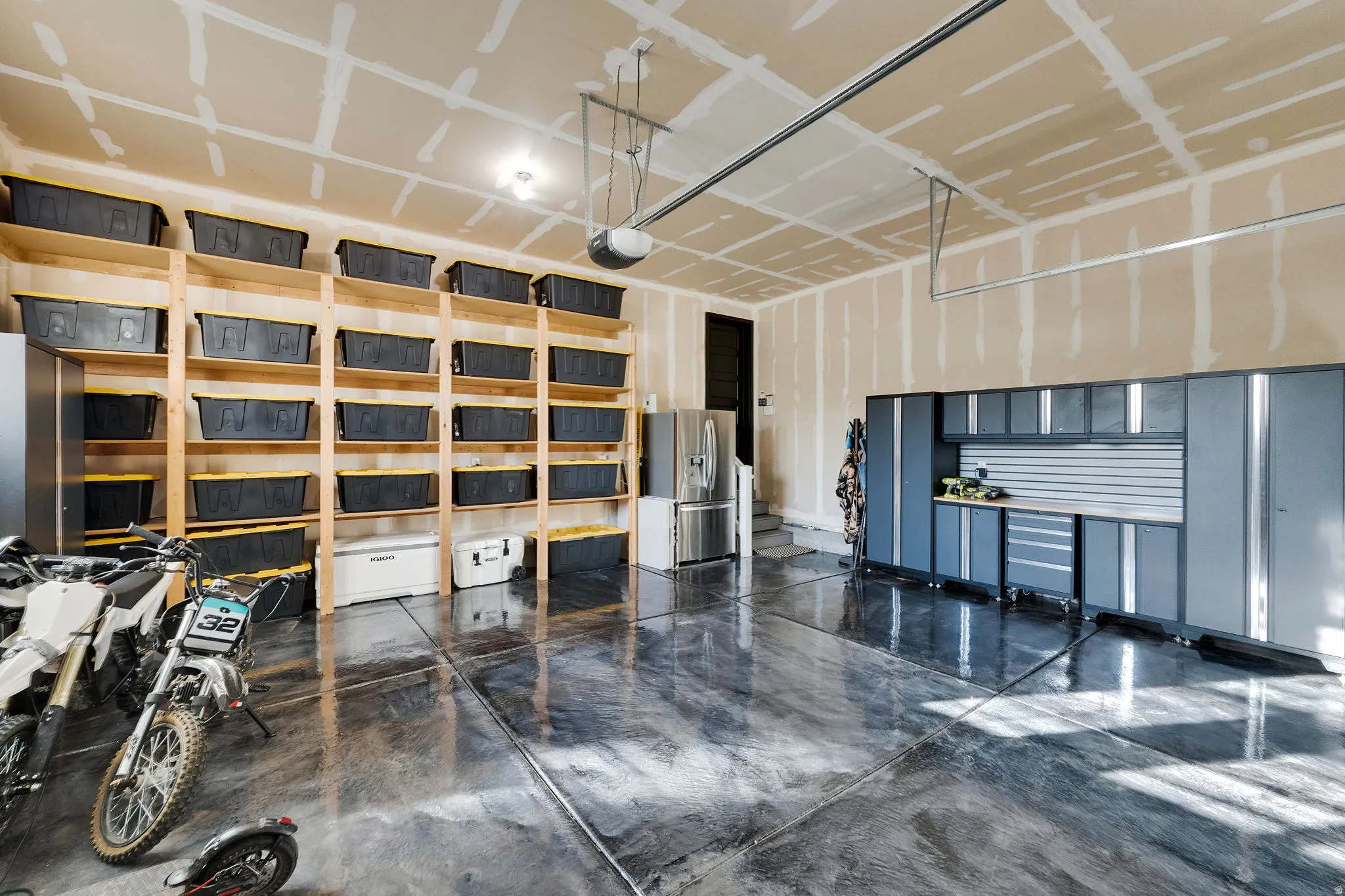 Spacious garage featuring an epoxy floor finish