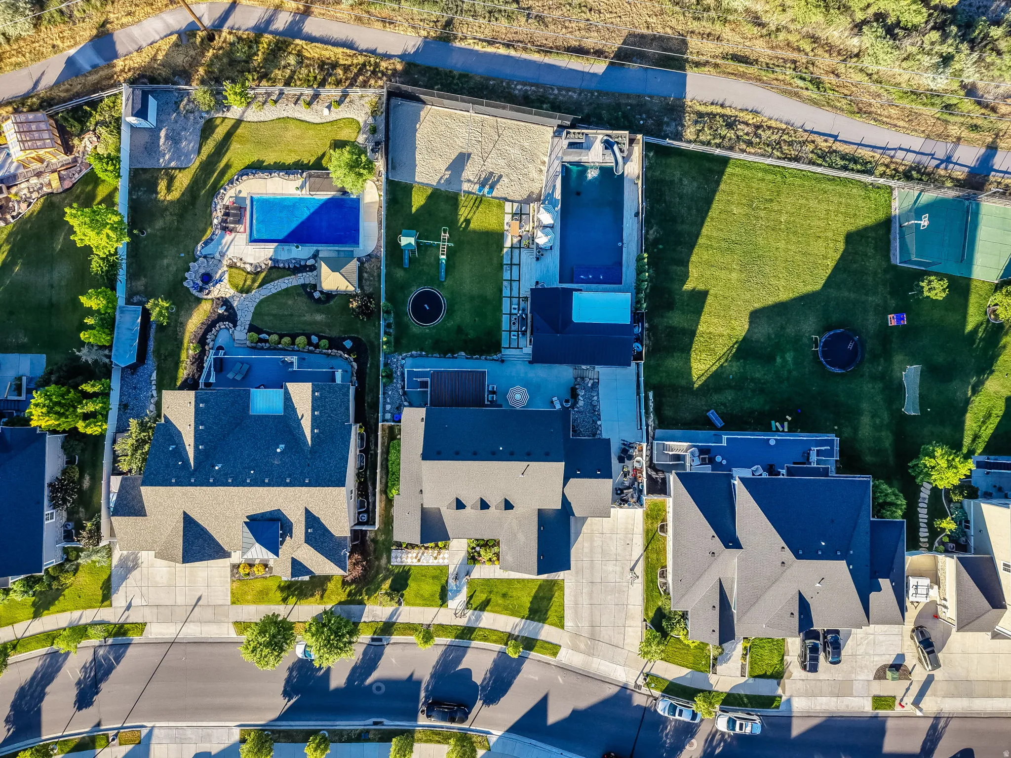 Aerial view showcasing multiple properties with extensive outdoor amenities