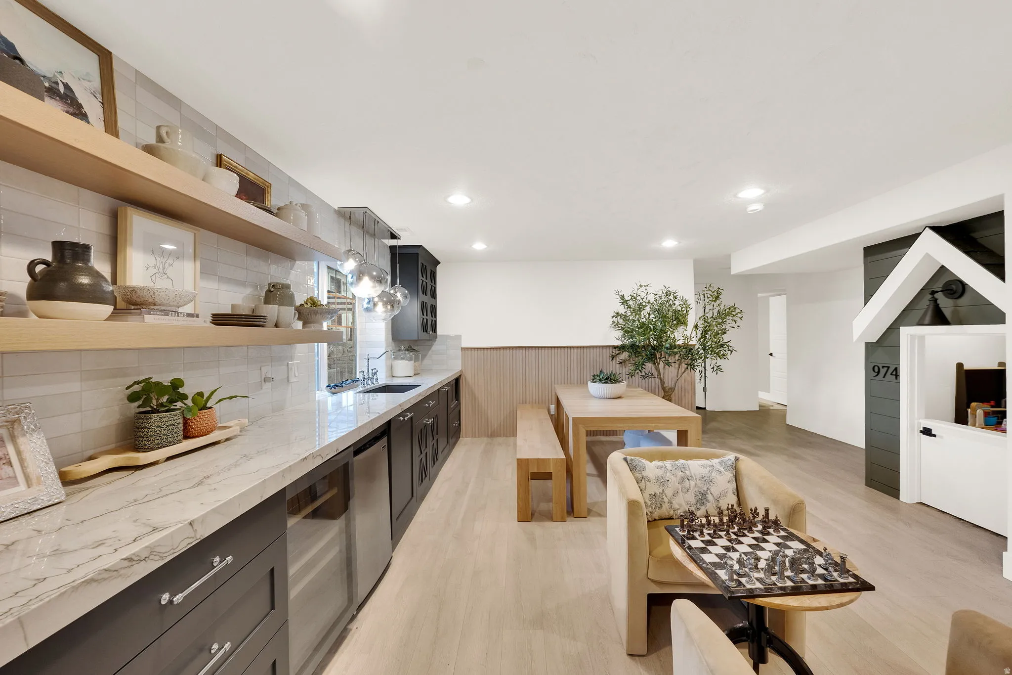 Spacious entertainment room featuring wood-finish flooring