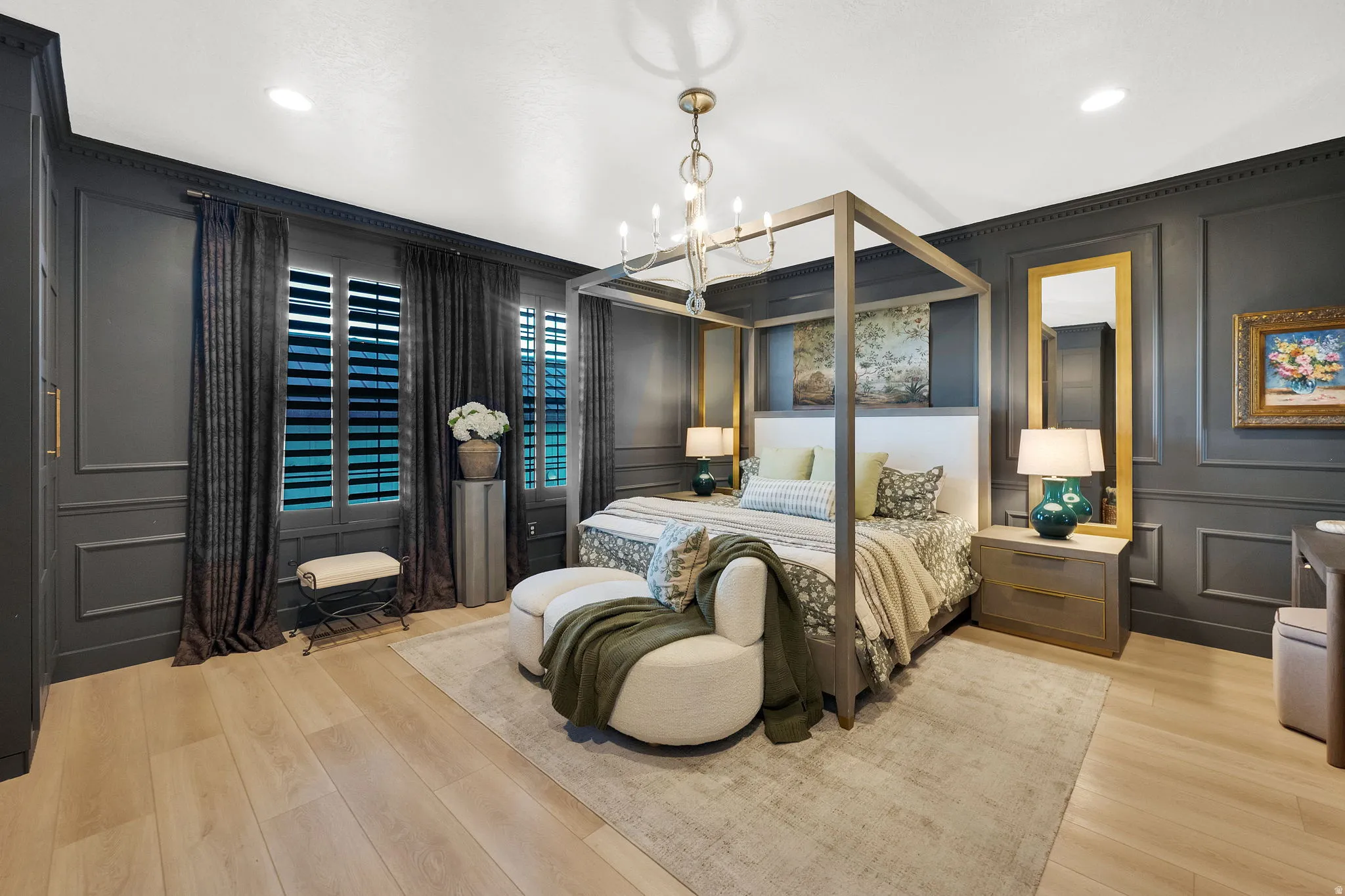 Wood-finish flooring with dark paneled walls featuring decorative molding