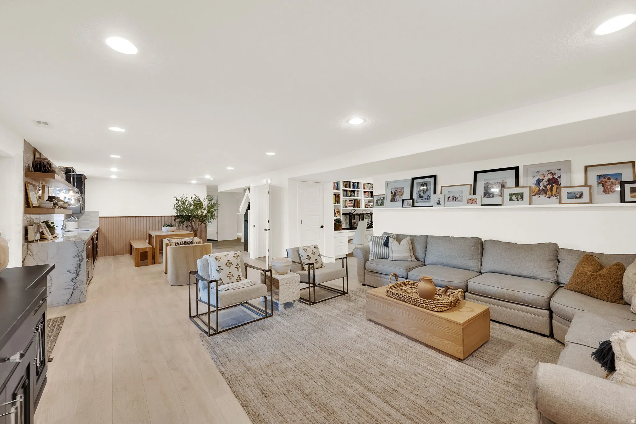 Open-concept lower level featuring recessed lighting and light wood-finish flooring