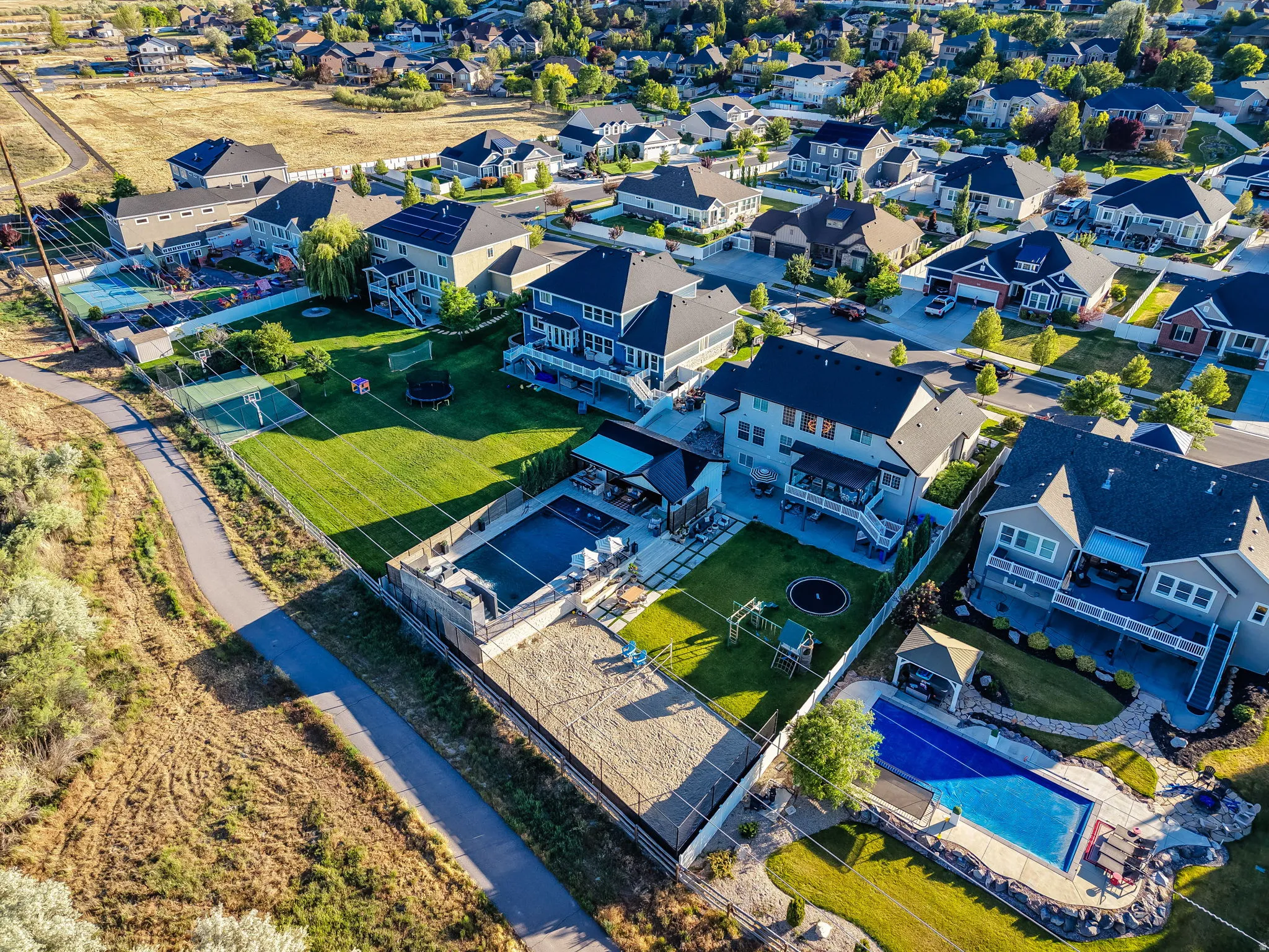 Expansive property featuring a private swimming pool, concrete patio, and an artificial turf putting green