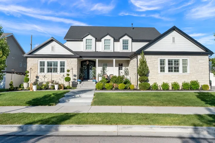 Stone and siding exterior with a dark roof and white trim