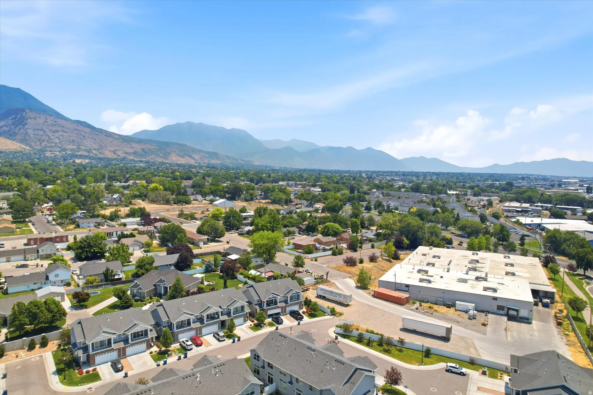 Mountainous backdrop framing a residential area with townhomes and detached properties