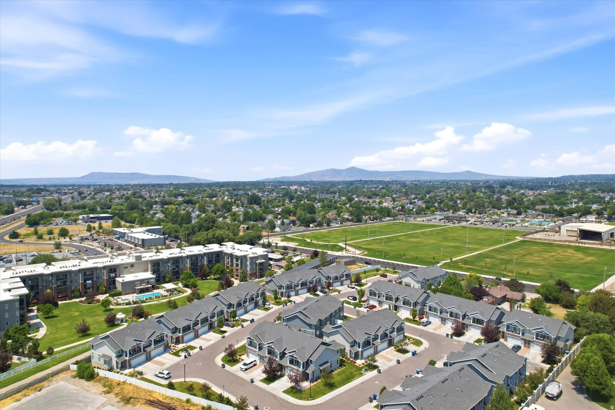 Aerial perspective showcasing a residential development with multiple townhome-style units