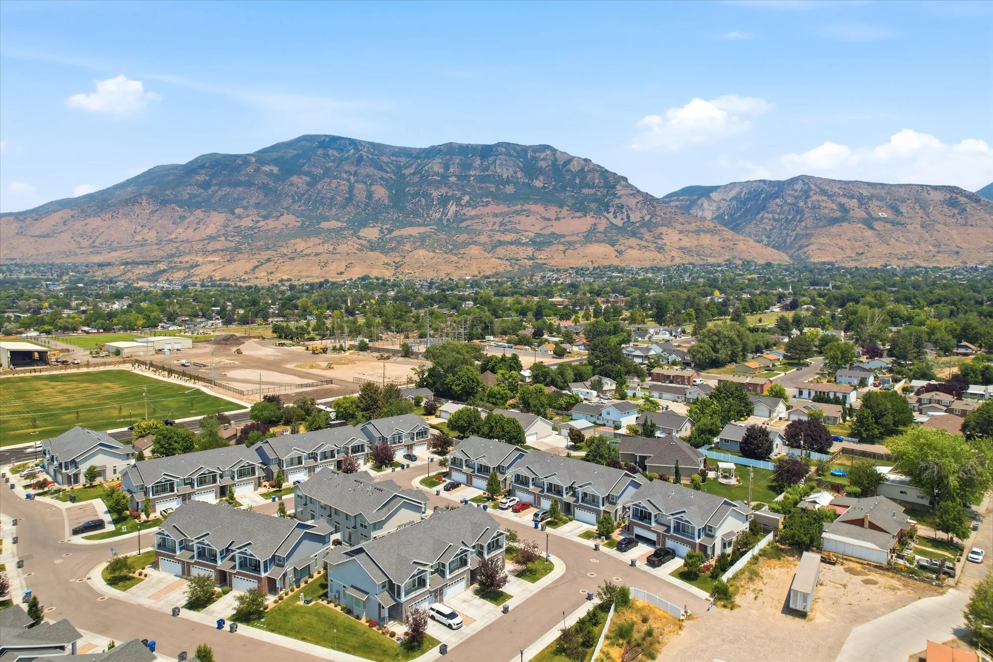 Aerial perspective showcasing a community of townhomes with mountain backdrop