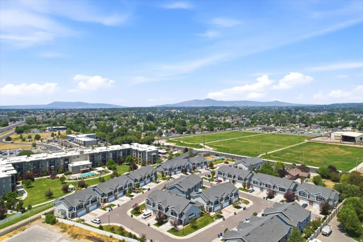 Aerial perspective showcasing a residential development with multiple townhome-style units
