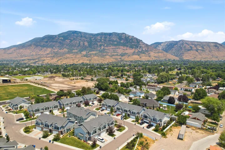 Aerial perspective showcasing a community of townhomes with mountain backdrop