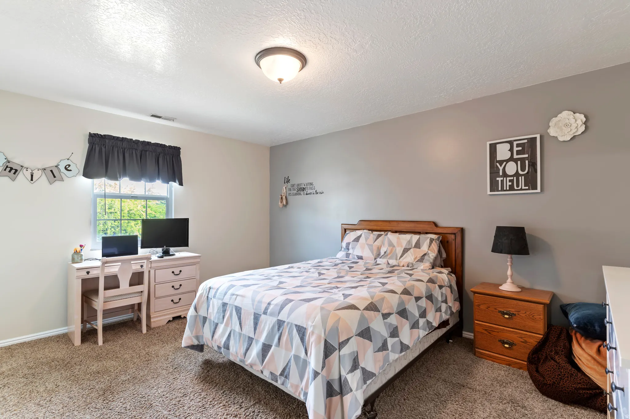 Wall-to-wall carpeting in a neutral tone and a ceiling-mounted light fixture