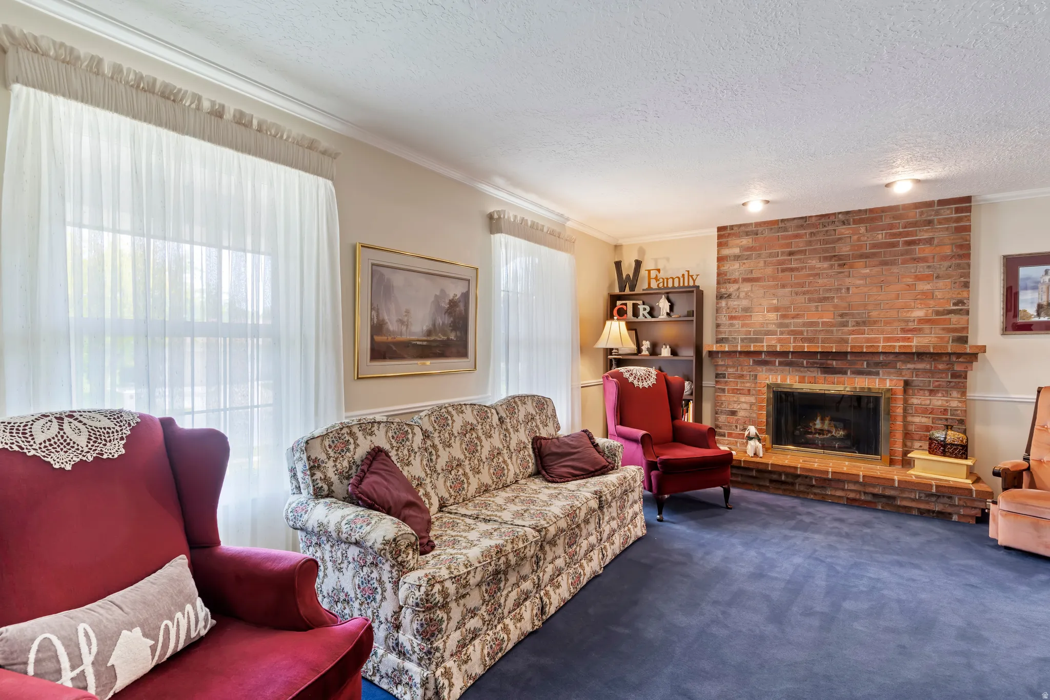Brick fireplace with a raised hearth, flanked by a built-in shelving unit