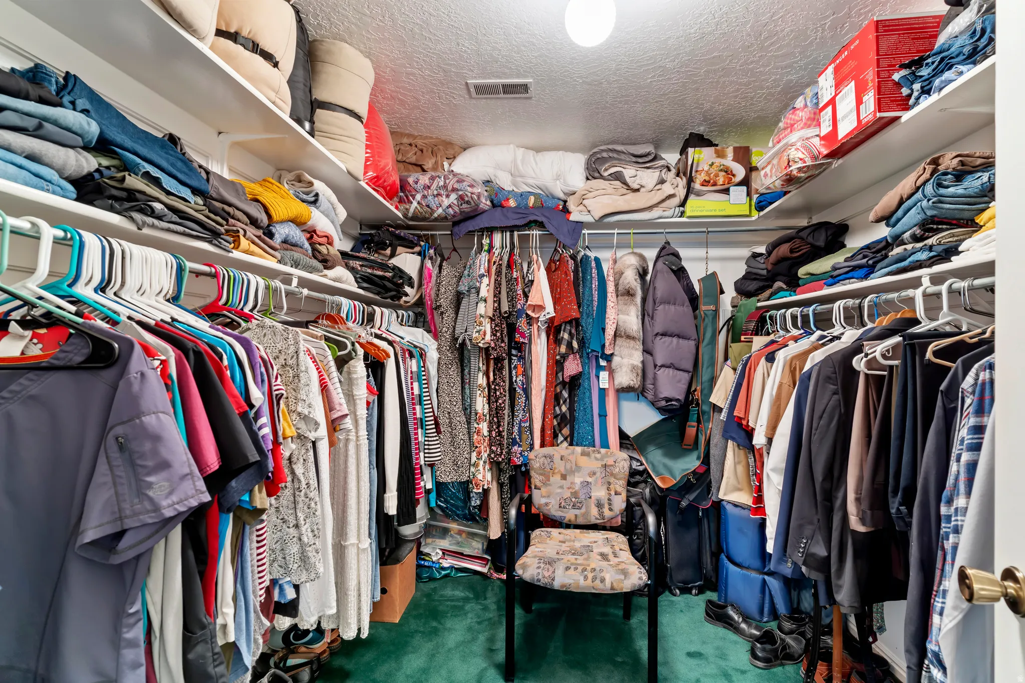 Walk-in closet featuring multiple hanging rods, extensive shelving, and recessed ceiling lighting