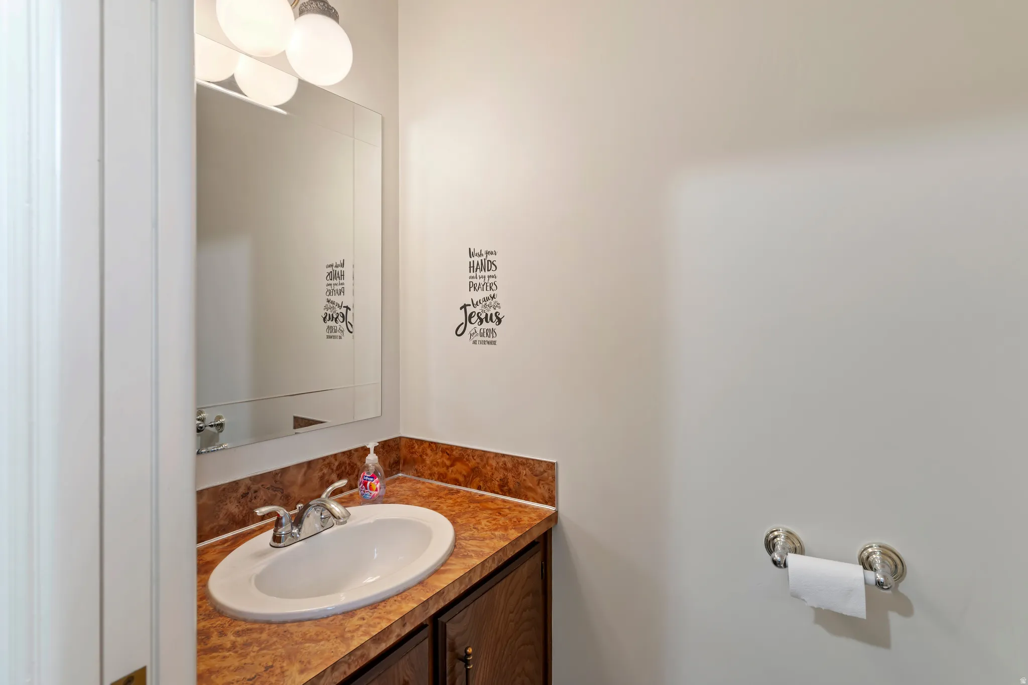 Bathroom vanity featuring an integrated sink, a brown-toned countertop, and a wood-finish cabinet