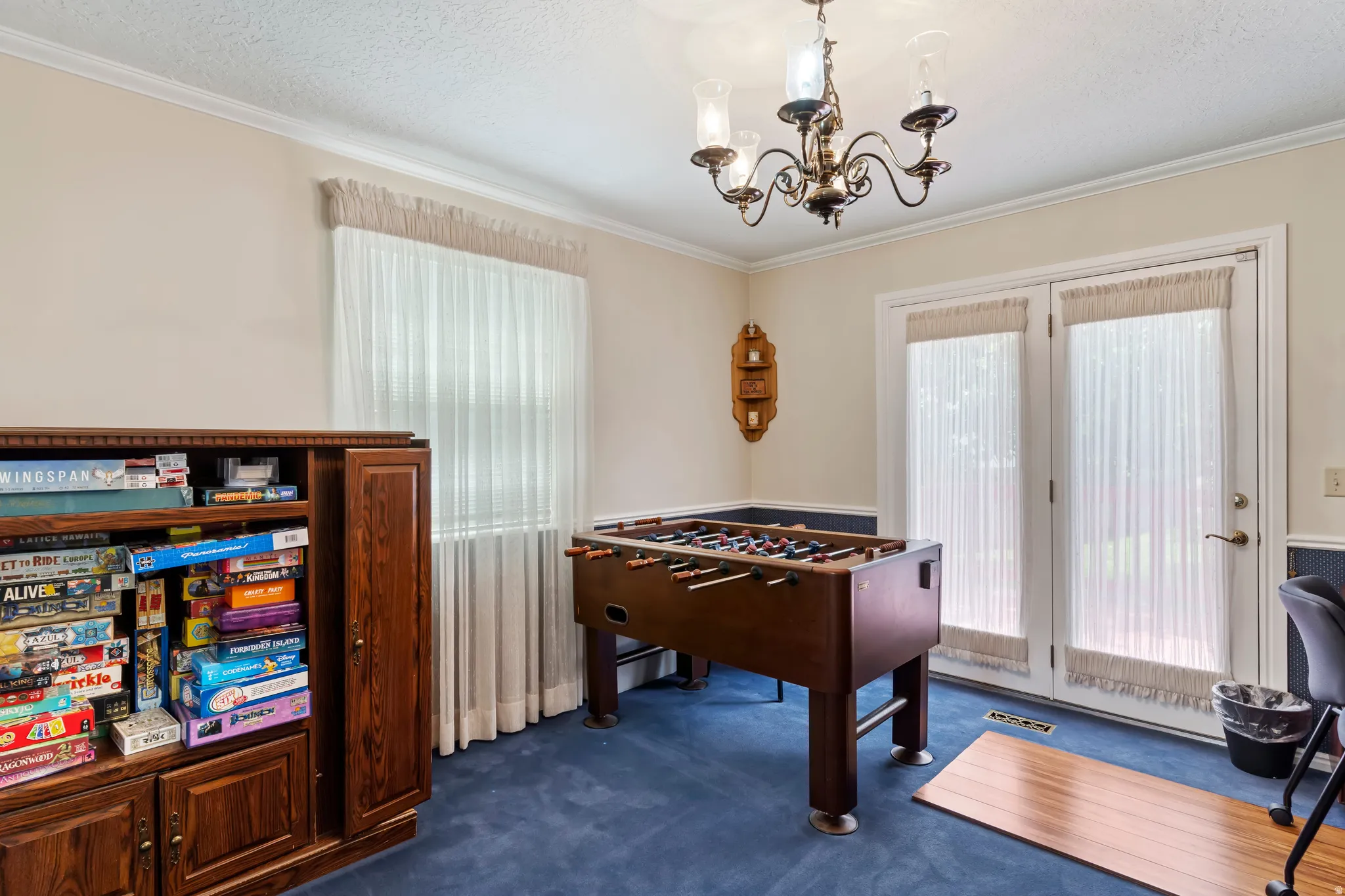 Room featuring plush blue carpet and light-toned walls