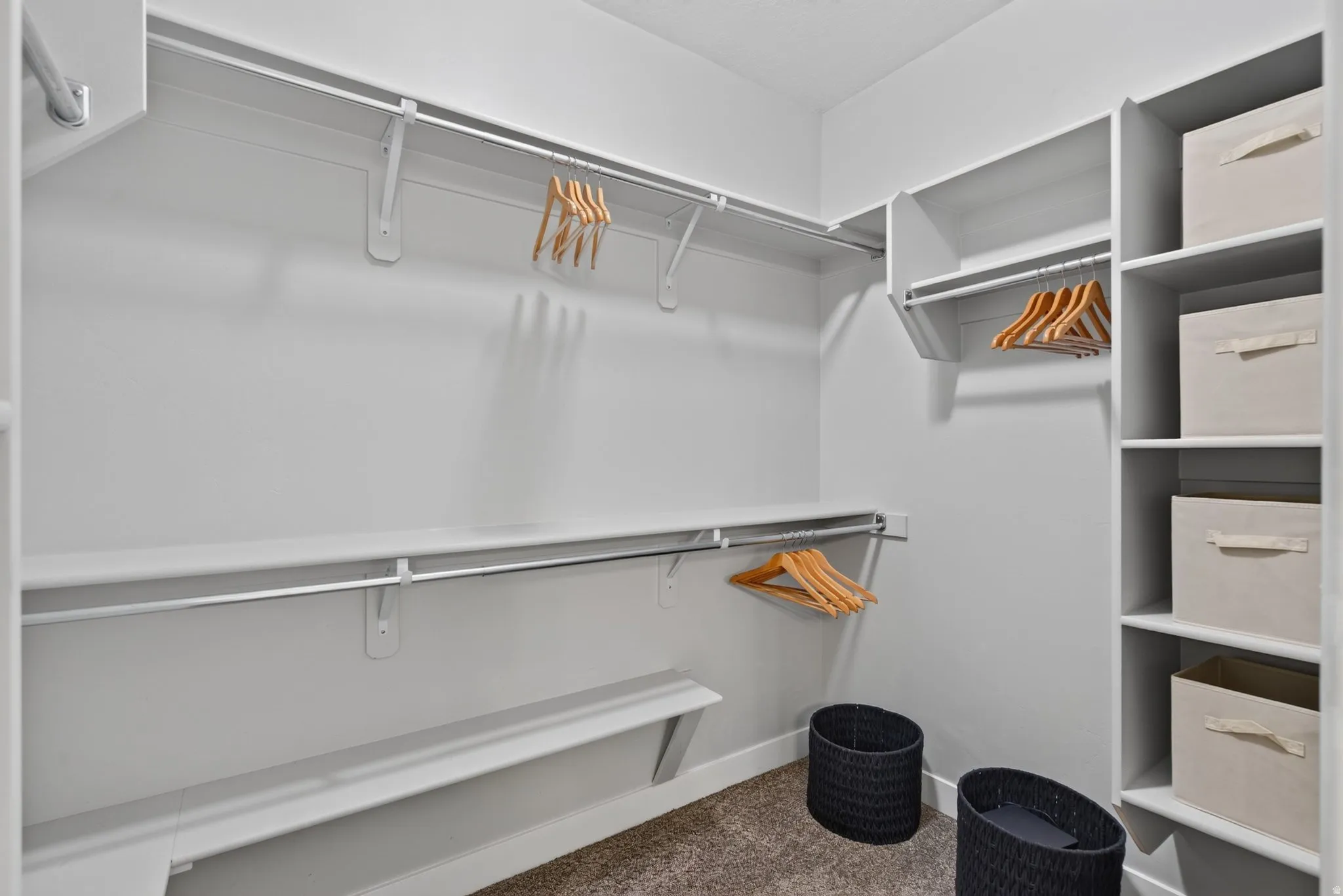 Spacious master closet featuring built-in shelving