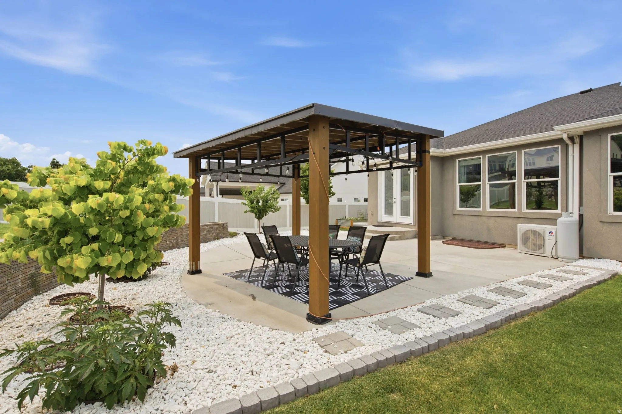 Covered backyard gazebo with outdoor dining space, updated landscaping, low-maintenance patio area, and easy access from the main living area.