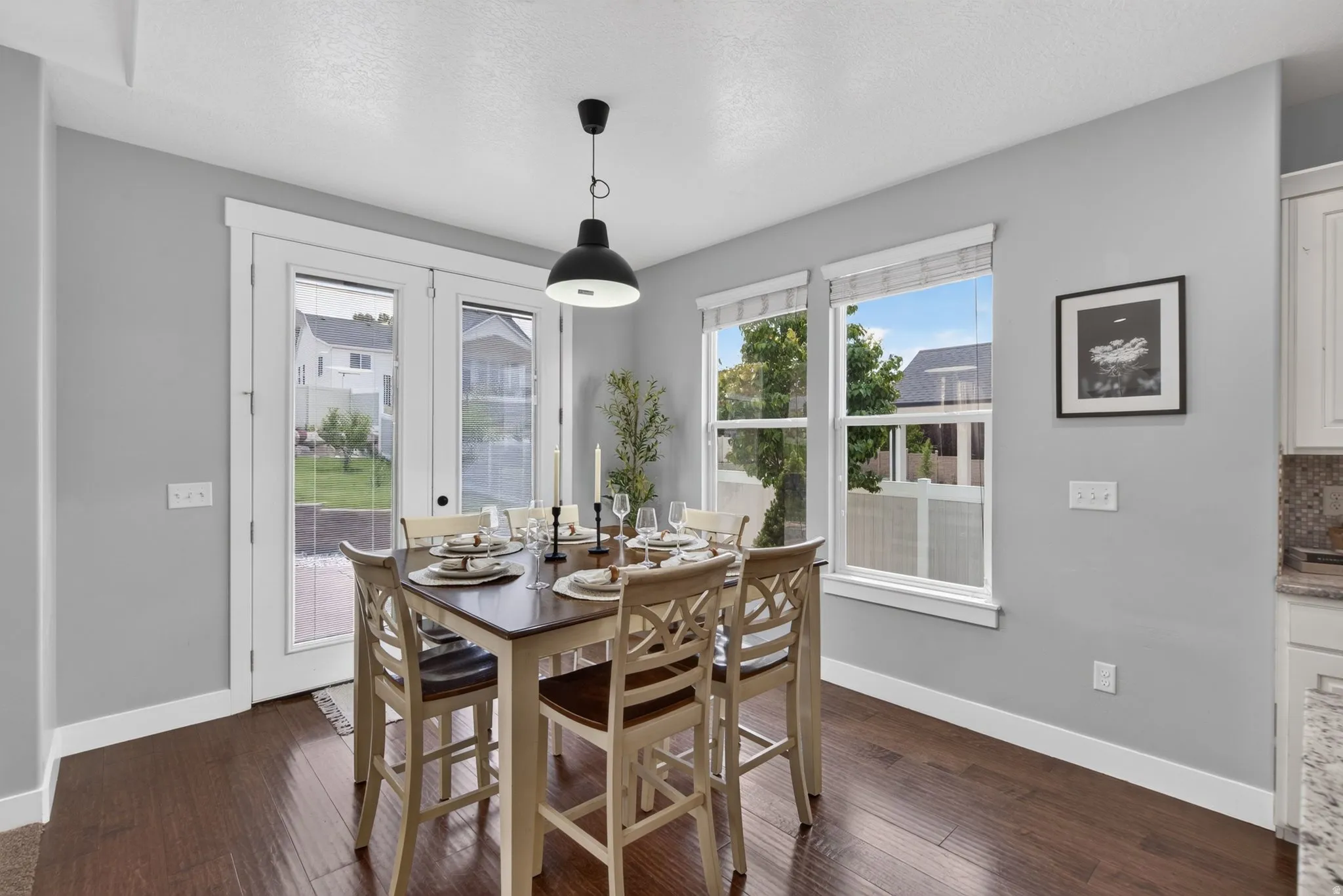 Dining area with backyard views, natural light, wood flooring, and easy access to the patio and outdoor living space.