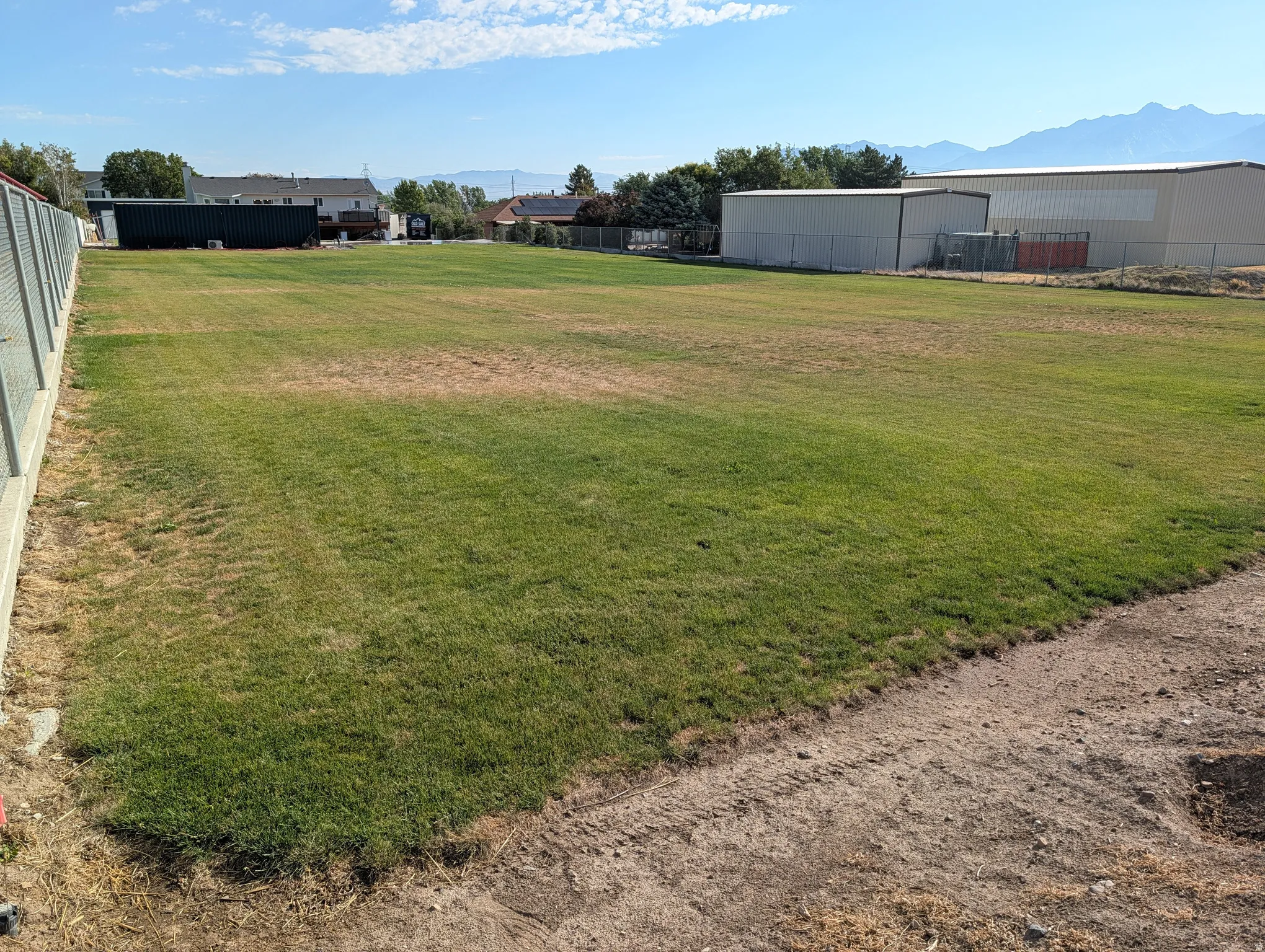 Expansive green space/ball field with distant mountain scenery