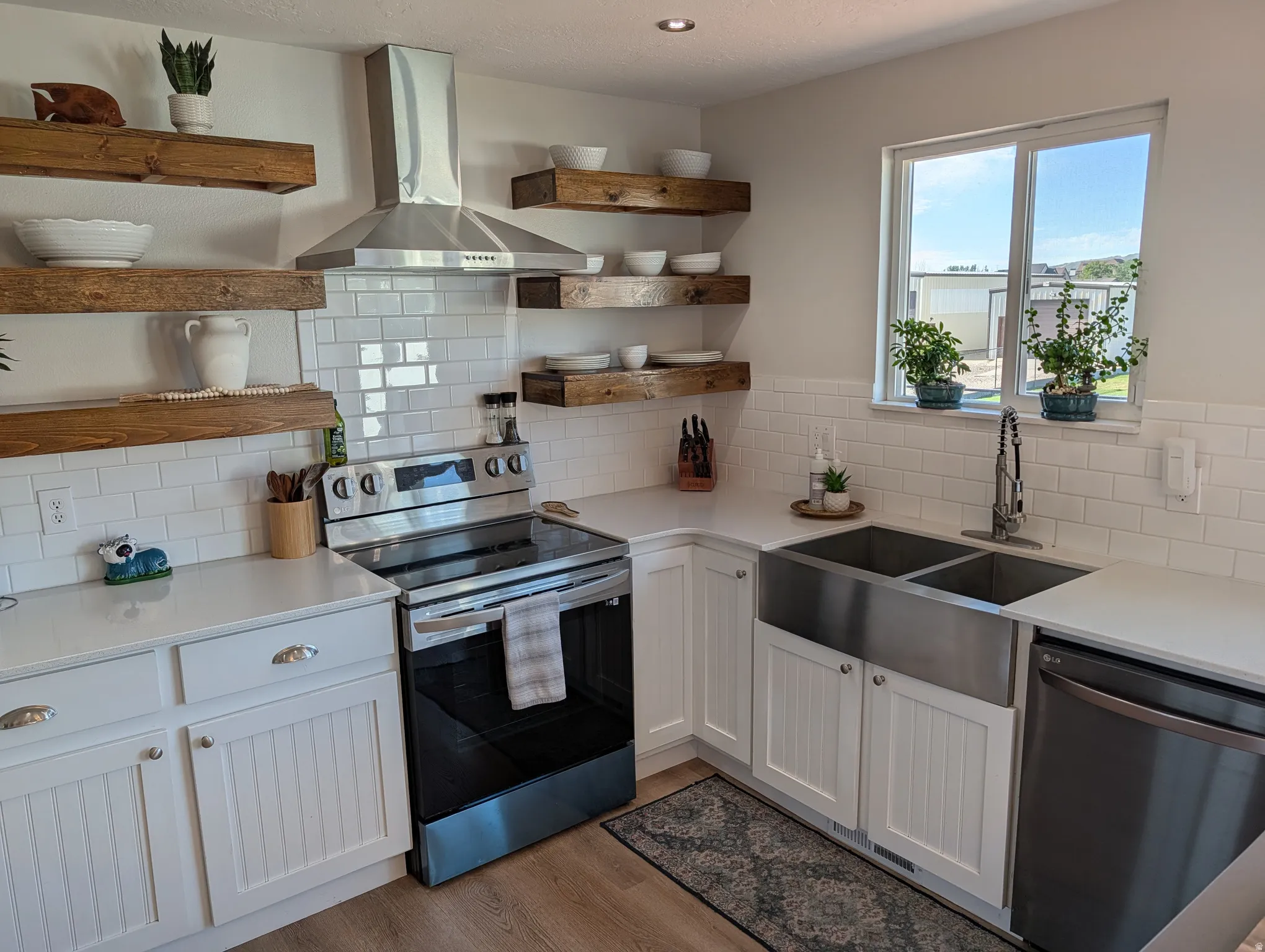 Modern kitchen featuring a stainless steel range and coordinating range hood