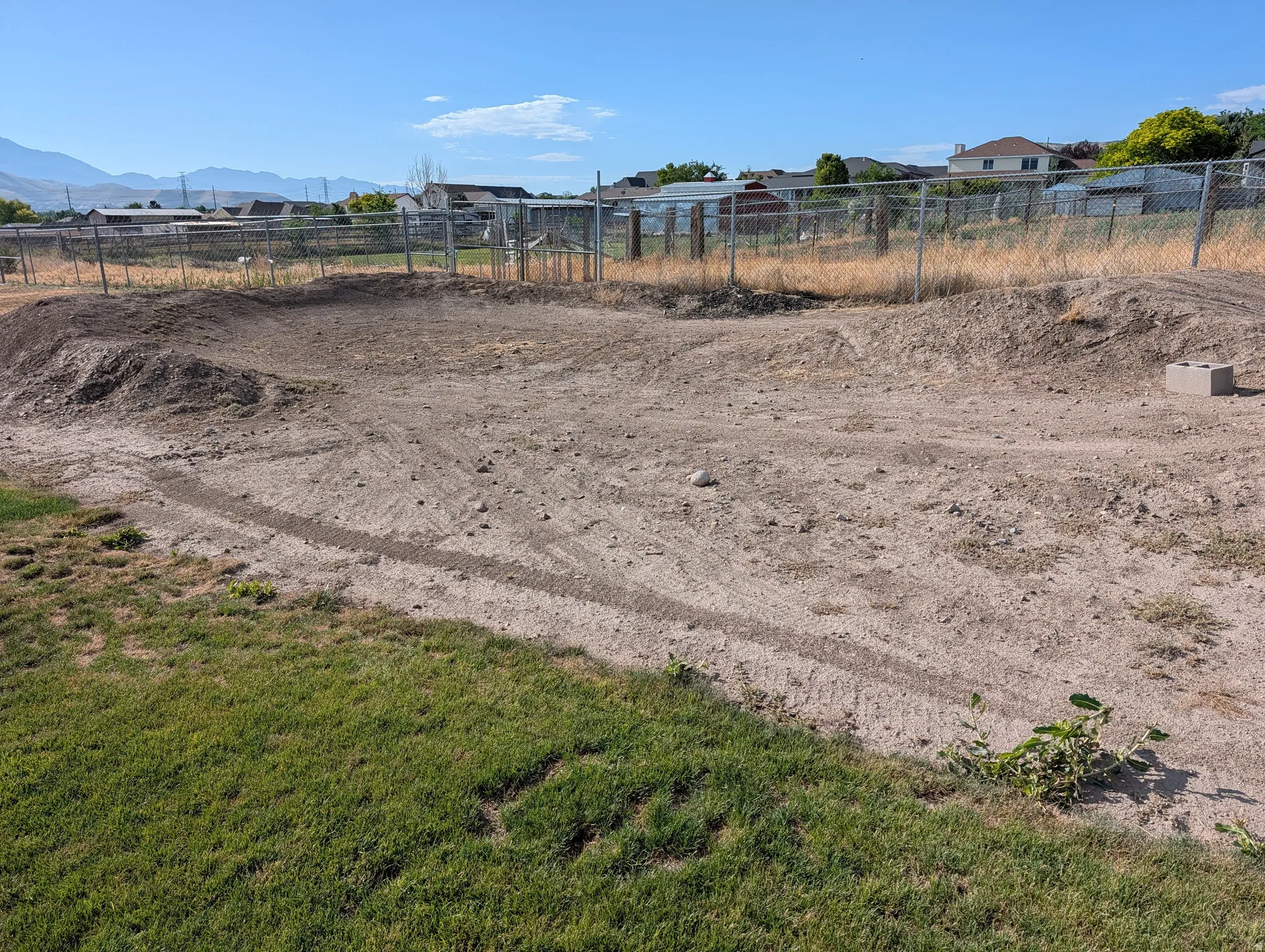 Dirt bike track. Expansive land parcel featuring existing ground contours and partial grass coverage