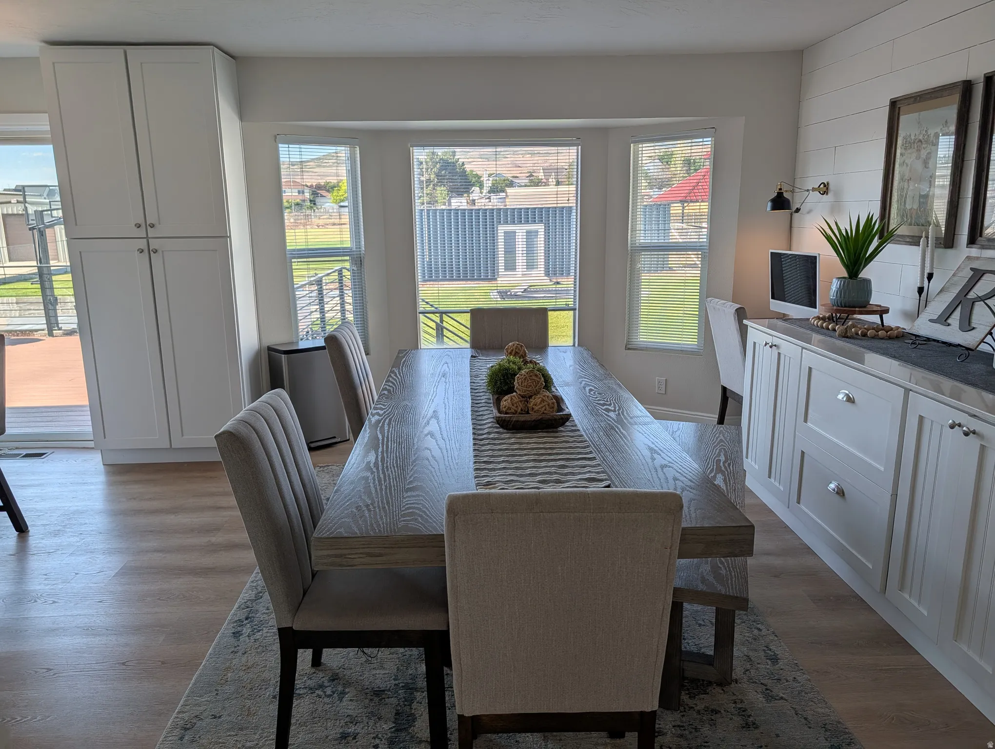Dining area featuring wood-finish flooring and a bay window