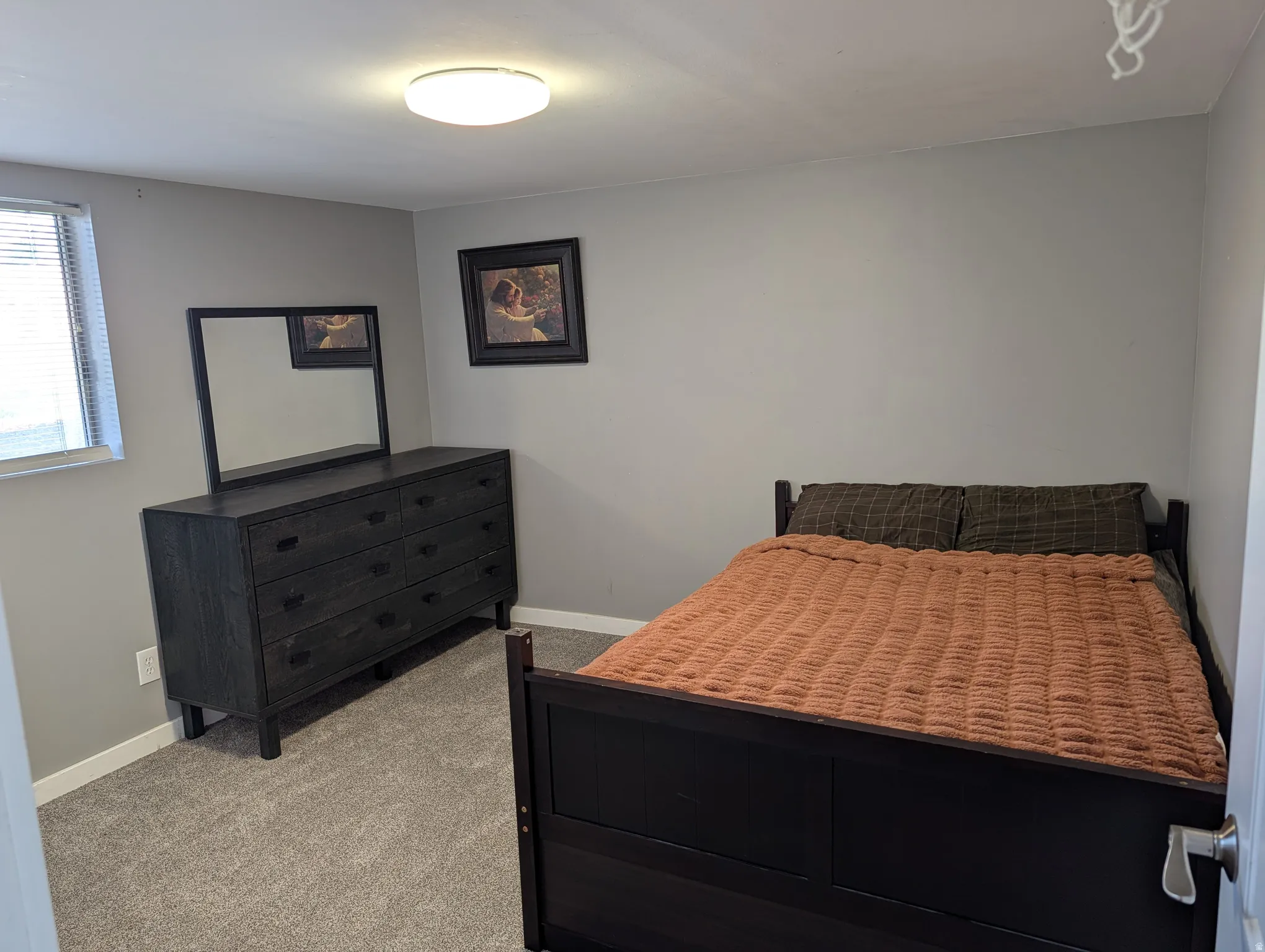 Bedroom featuring light grey wall paint and light grey carpeting