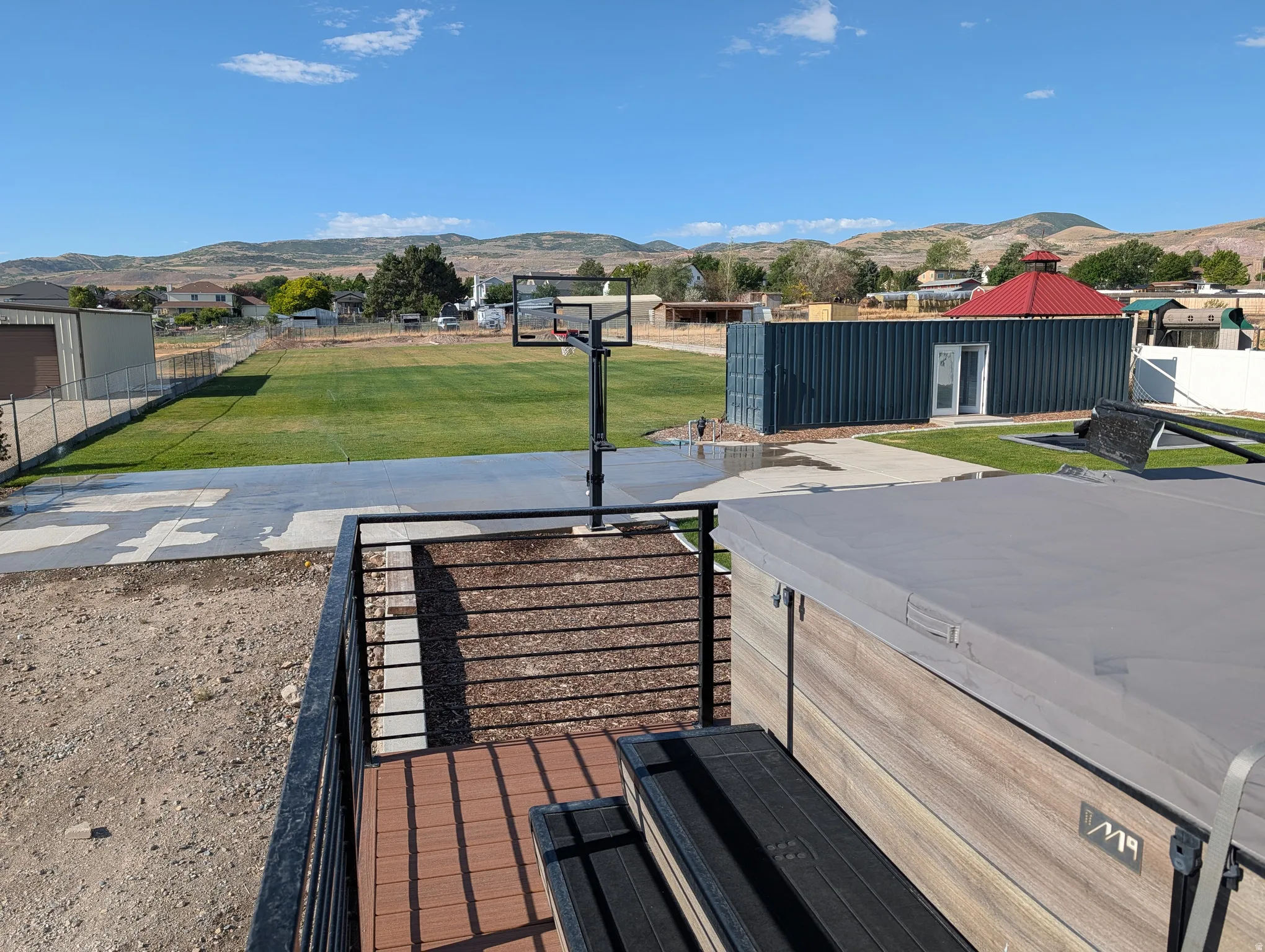 Exterior deck featuring composite decking and black metal railings.
