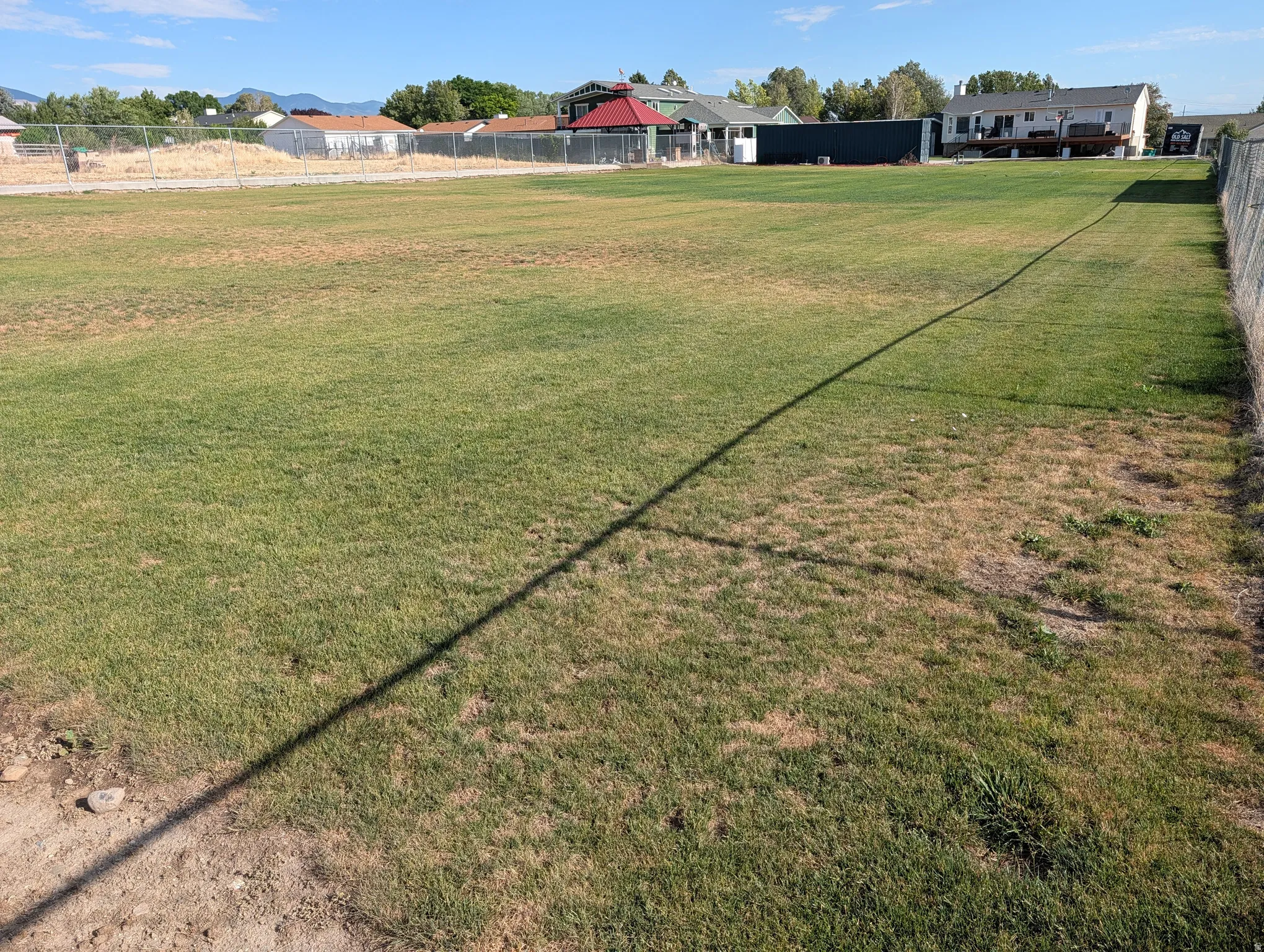 Expansive green space/ball field with established perimeter fencing