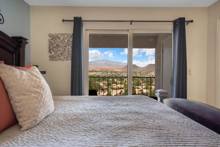 Sliding glass door opening to a private balcony with black metal railing