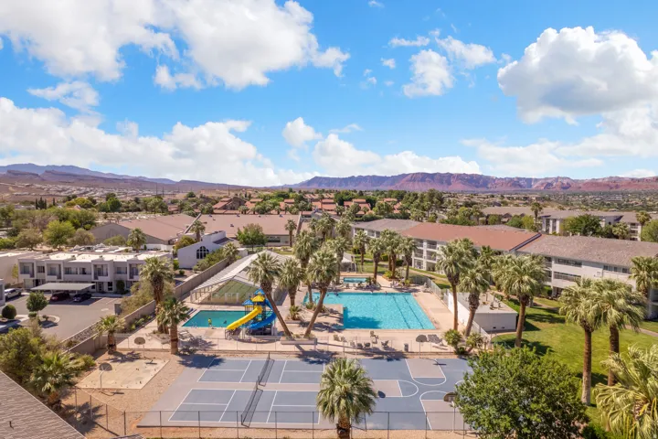 Community amenities featuring a large outdoor swimming pool, a covered pool area, a waterslide, and multiple sports courts